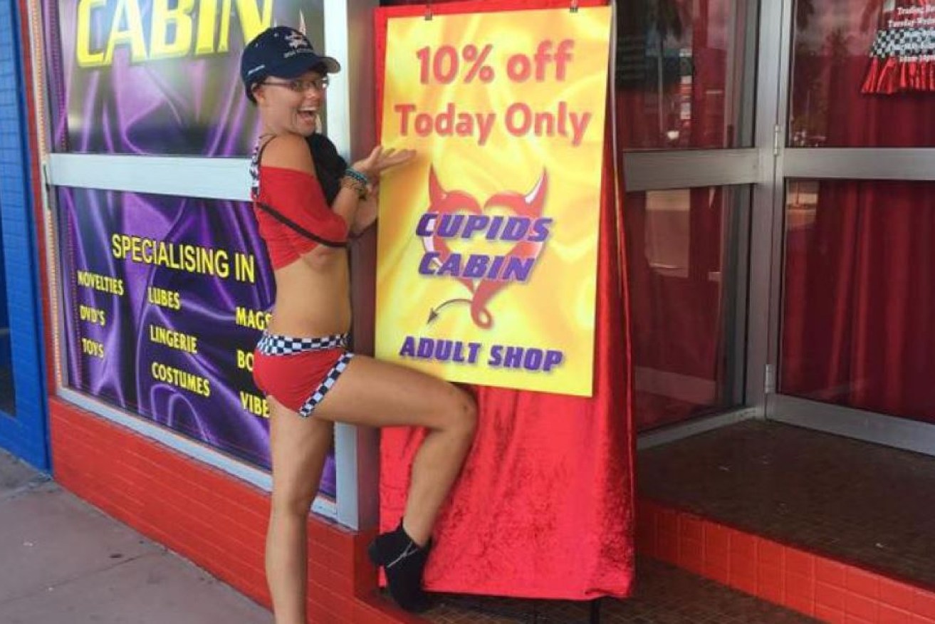 One Nation candidate Mark Thornton's erotic emporium in Townsville gets a little promotional help from a scantily clad model.