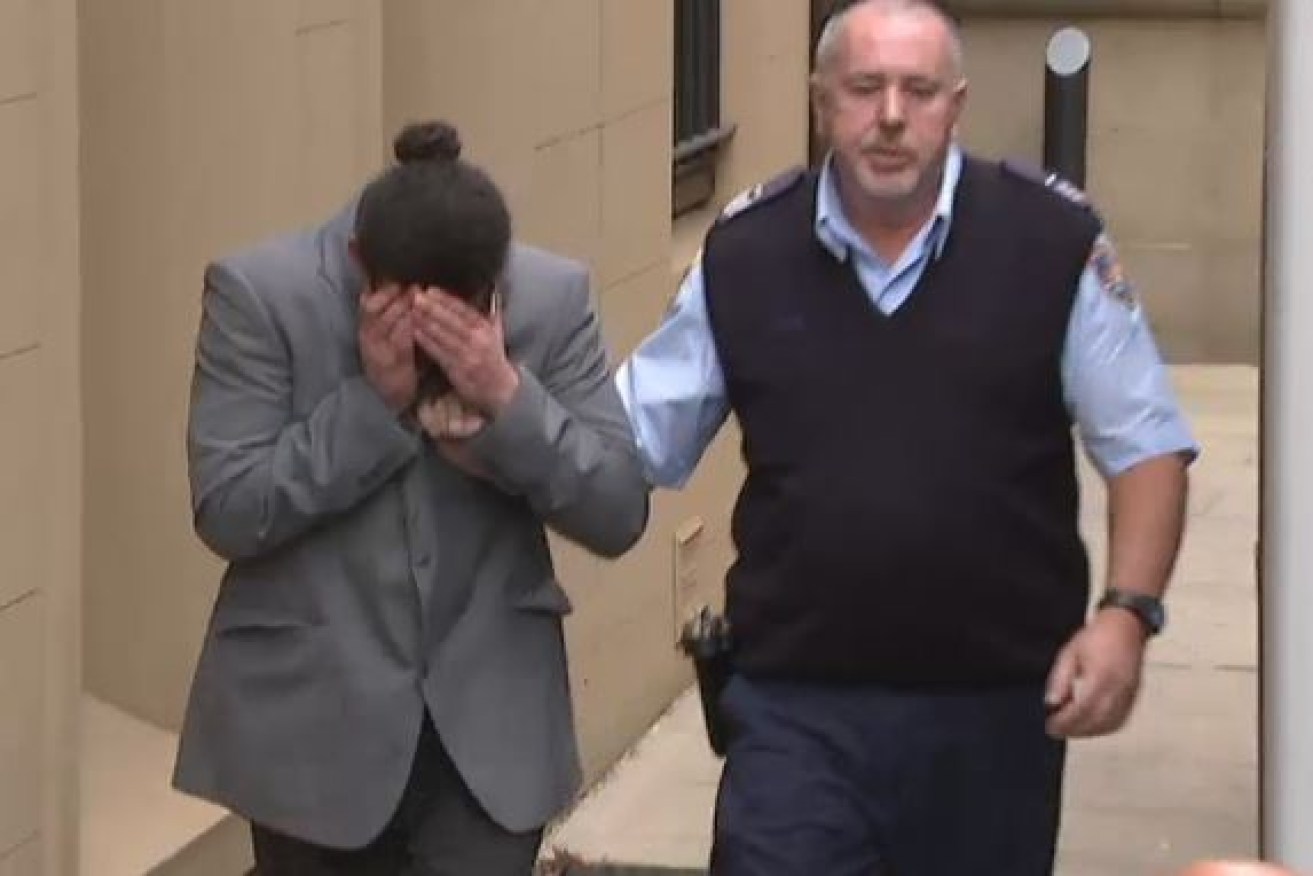 Killer Aymen Terkmani hides his face as he is led from court.