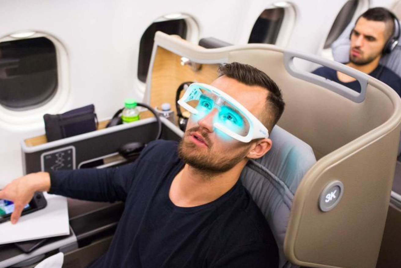 Socceroos player Bailey Wright enjoys the 'anti-fatigue' glasses dished out on the flight to Australia.