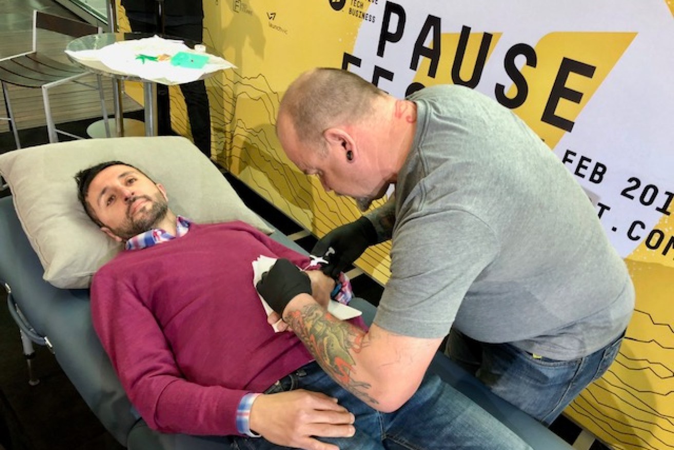 A festival VIP pass holder has the microchip injected under his skin. 