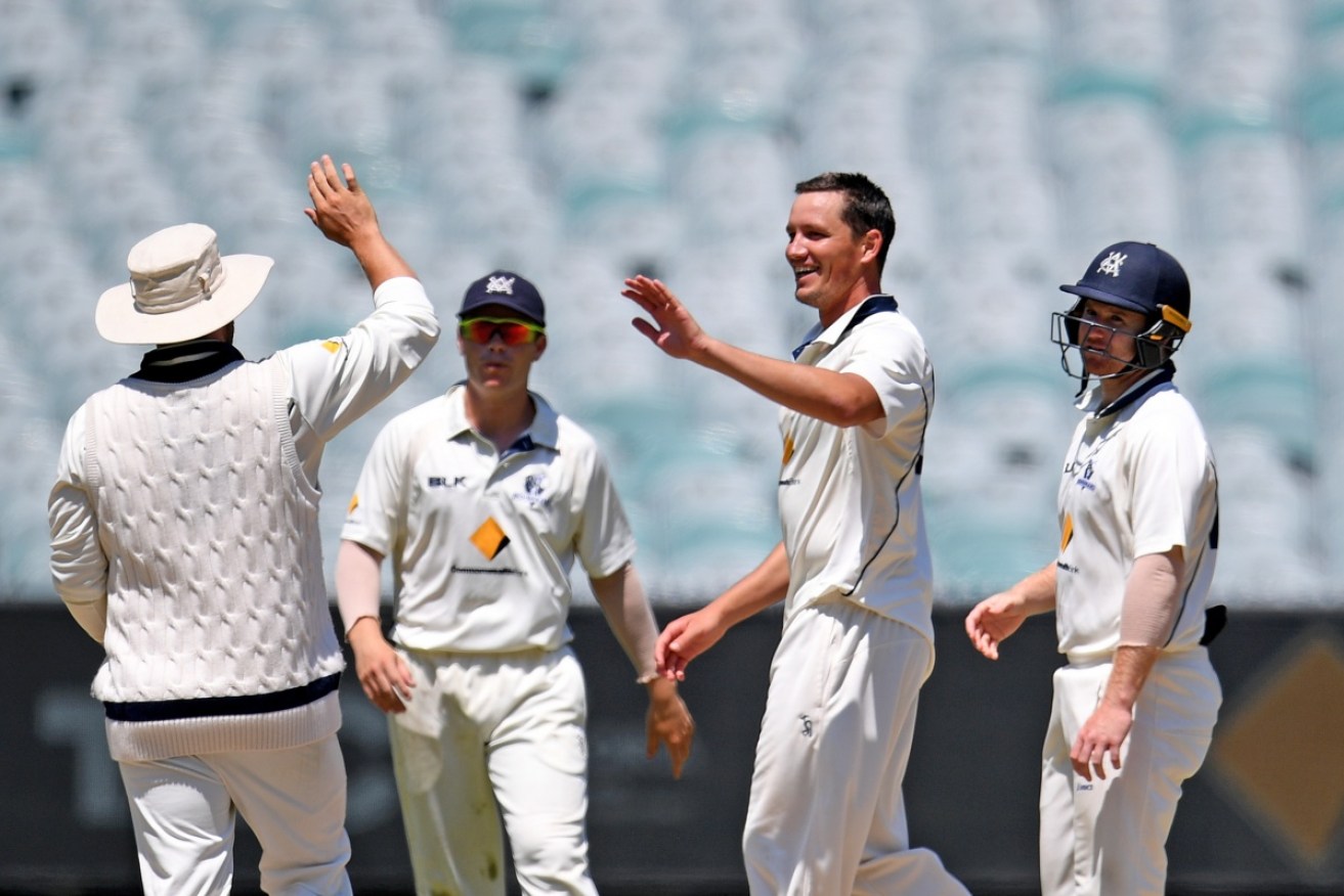 Bowler Chris Tremain (second right) of the Bushrangers celebrates after the dismissal of Will Bosisto at the MCG.  