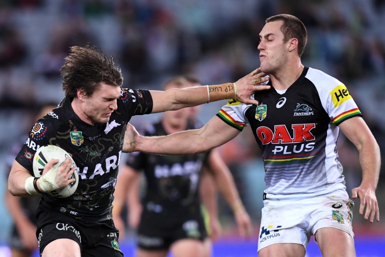Souths’ Angus Crichton fends off Penrith’s Isaah Yeo in July at ANZ Stadium in Sydney. 