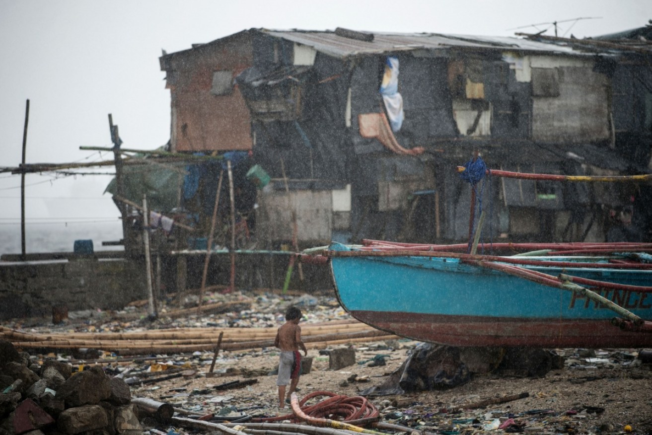 A boy walks among devastation in the Philippines.