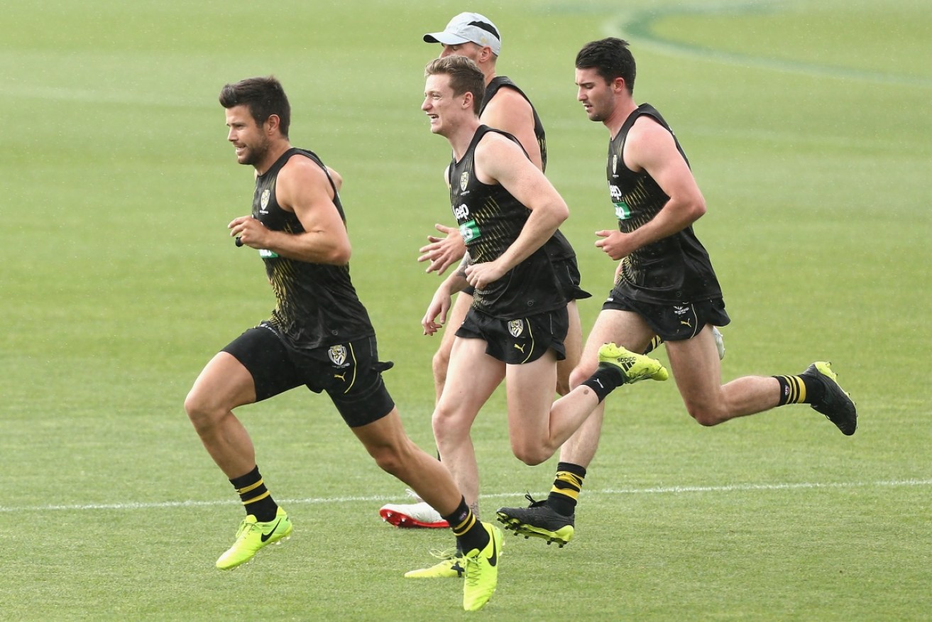 Trent Cotchin leads his Richmond teammates in training.  