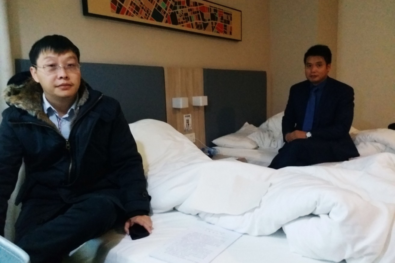 Yan Xin (L) and Ge Yongxi (R), lawyers for activist Wu Gan known by the online pseudonym 'Super Vulgar Butcher', sit at a hotel after Wu was sentenced.