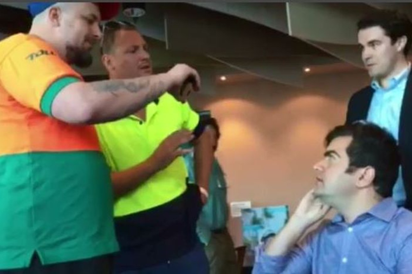 Neil Erikson, dressed in the Toll shirt, was one of a group of men who ambushed senator Sam Dastyari