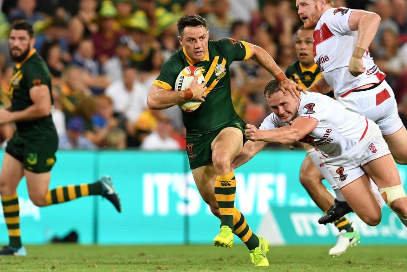 Cooper Cronk bursts through the English line during Saturday night's big game -- his last appearance for Australia.