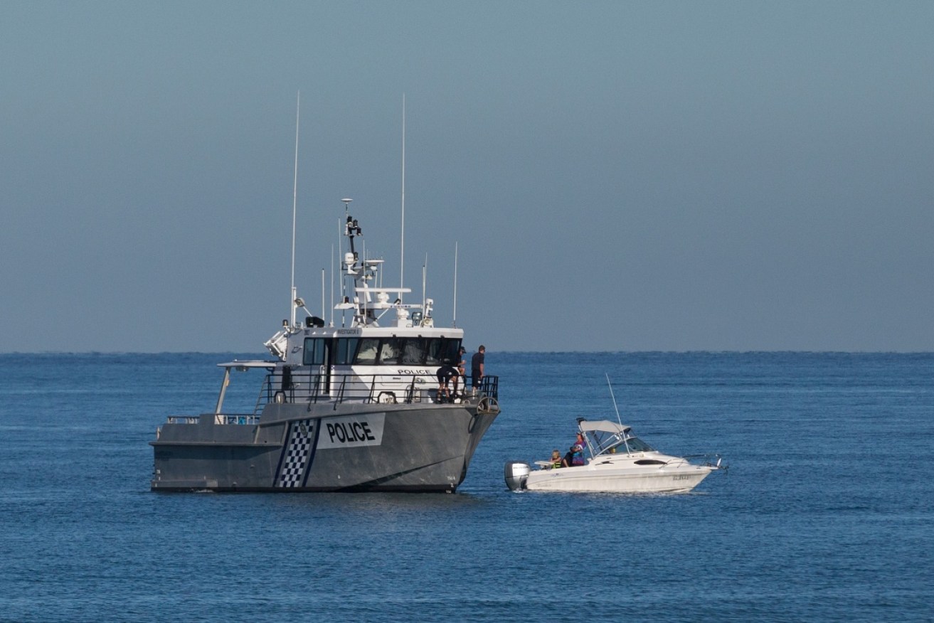 A police vessel searching the water at Glenelg Beach.