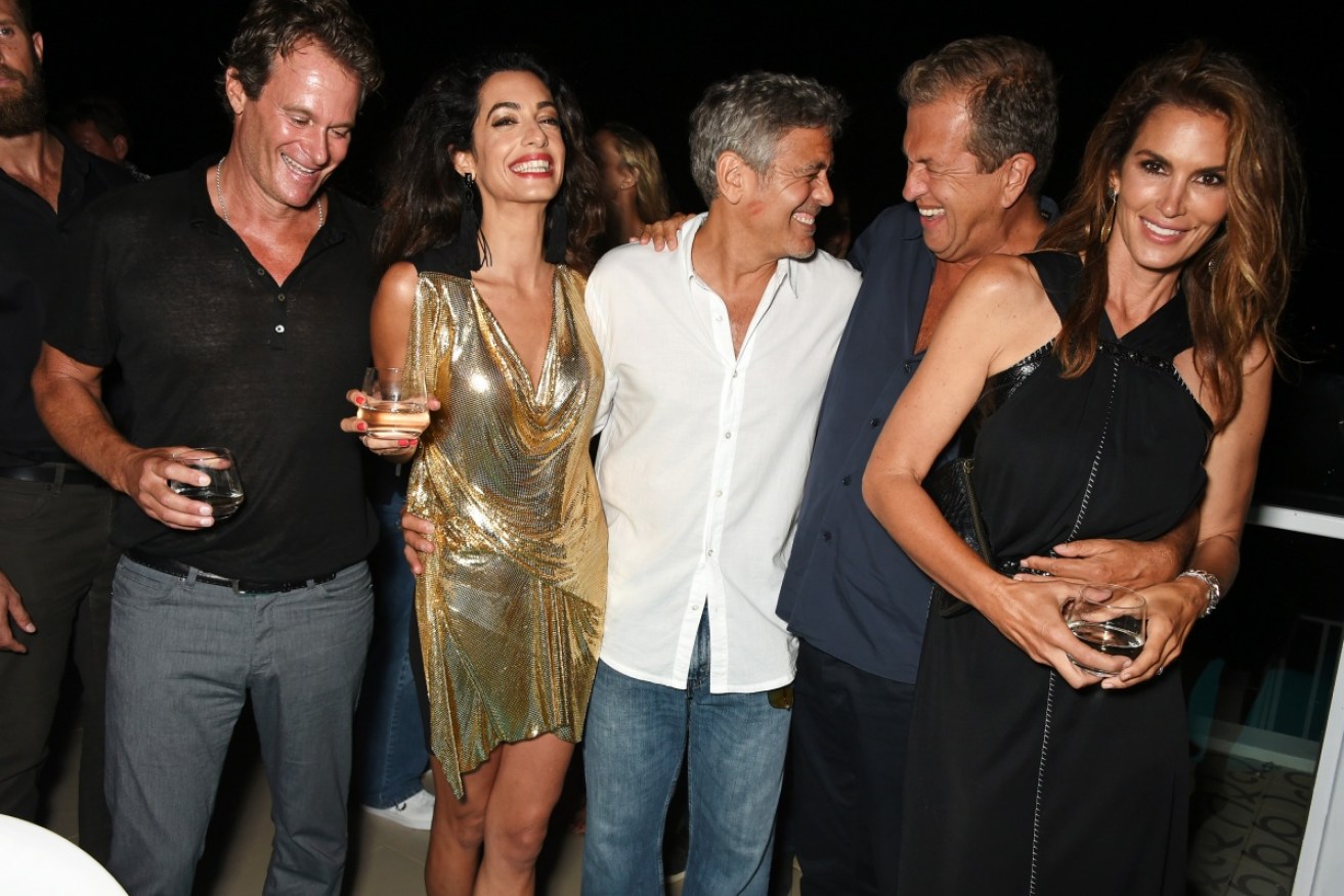 It pays to be one of George Clooney's (centre) close friends. Just ask Rande Gerber (far left).