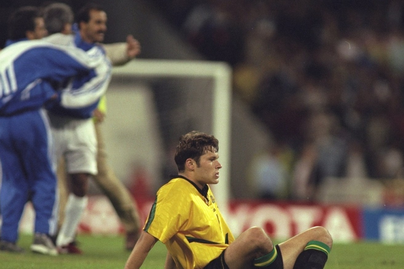 A dejected Mark Viduka contemplates the heartbreaking result.