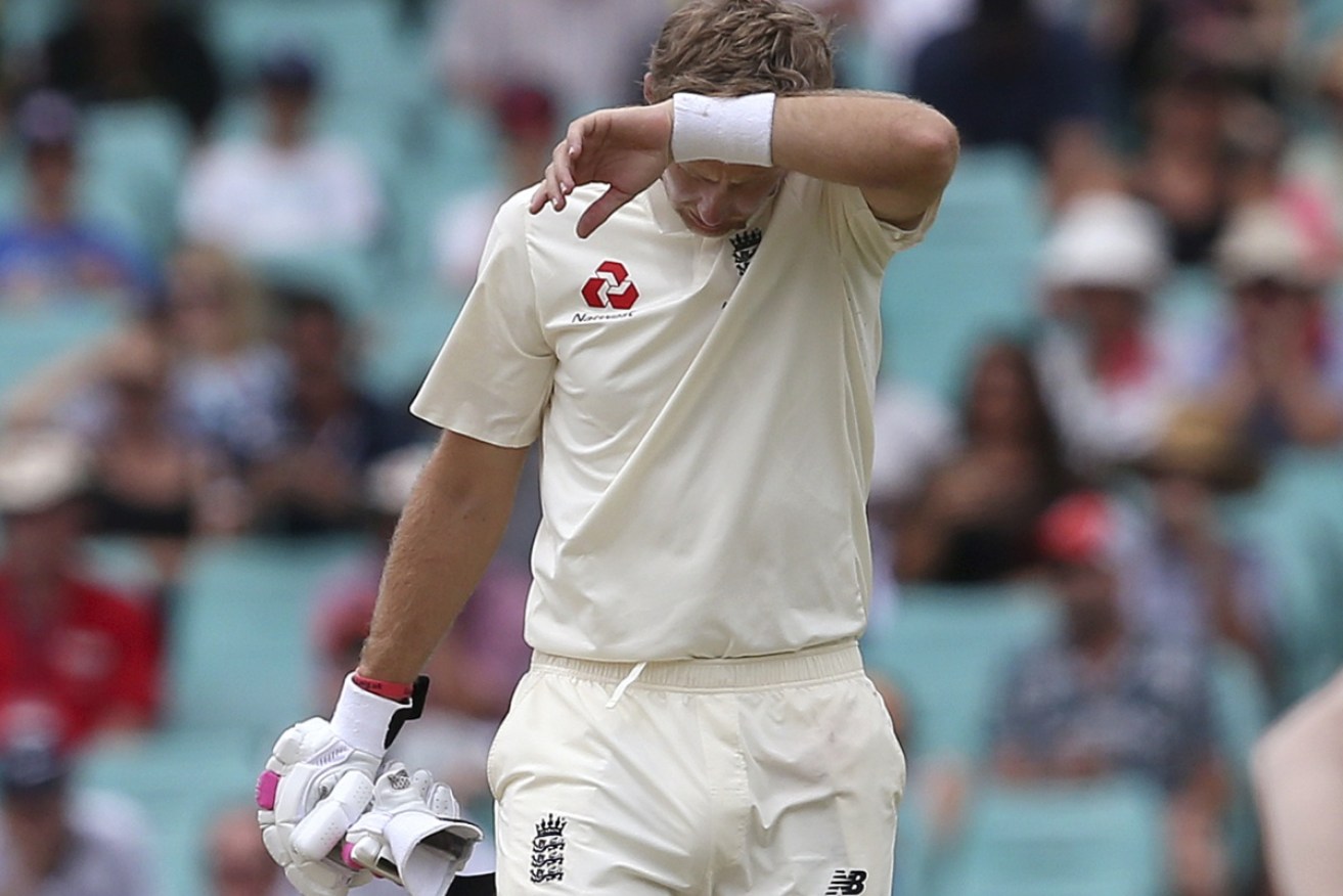 England's Joe Root wipes his face in break during the last day of their Ashes cricket test match in Sydney. 