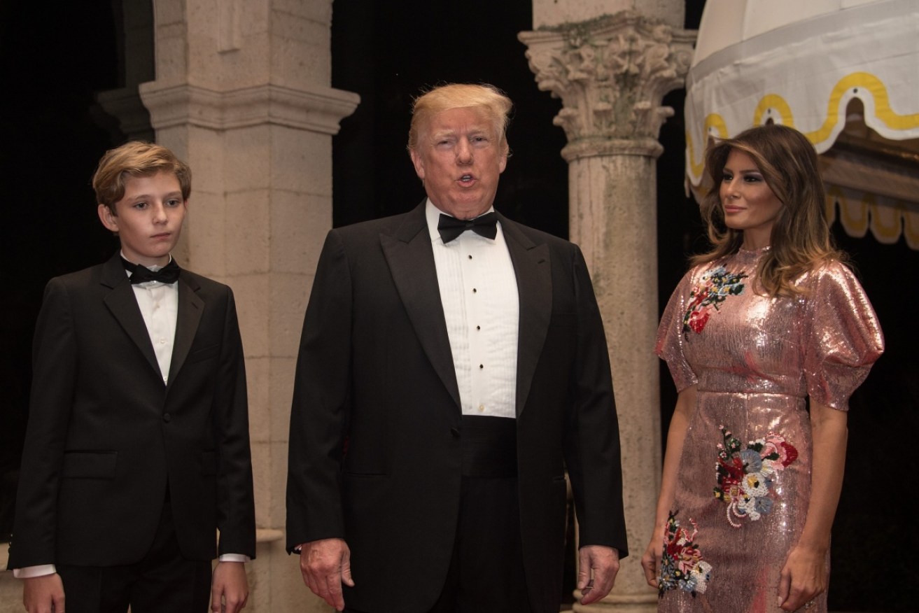 Donald Trump rings in the new year with son Barron and wife Melania at his Mar-a-Lago estate.