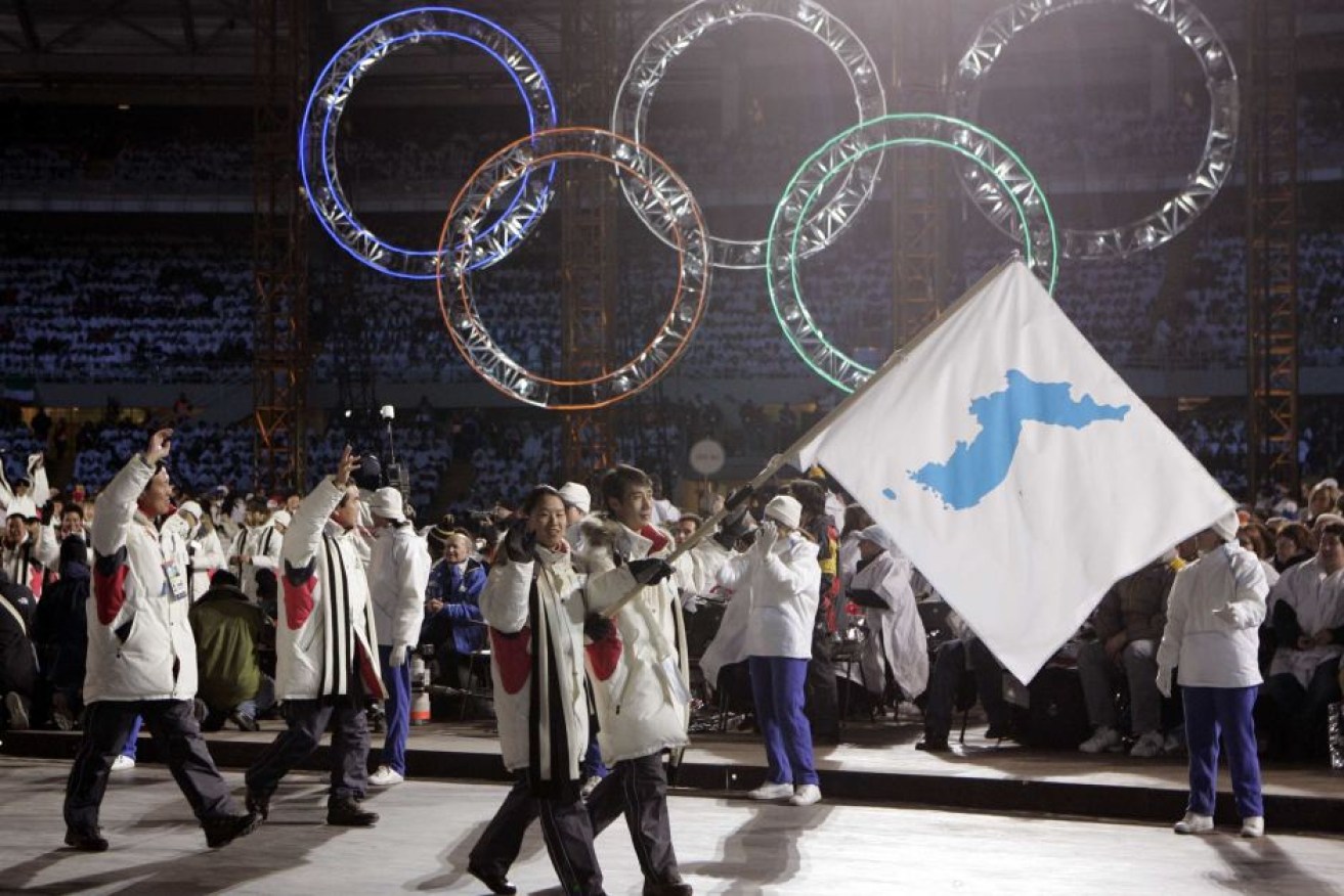 Korean flag-bearer's Bora Lee and Jong-In Lee, carry a unification flag at the 2006 Winter Olympics opening ceremony.