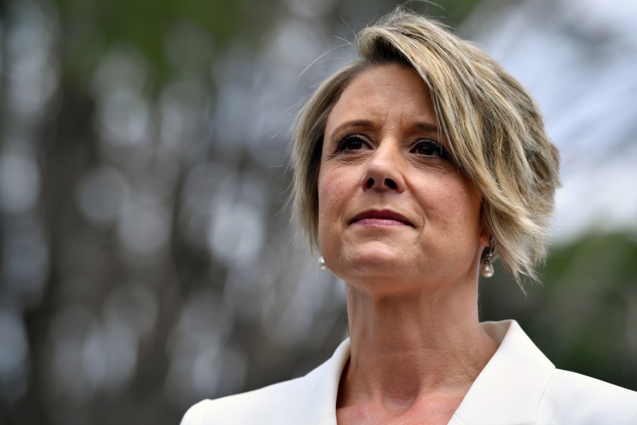 Two people have been charged over online threats made against Labor senator Kristina Keneally. 