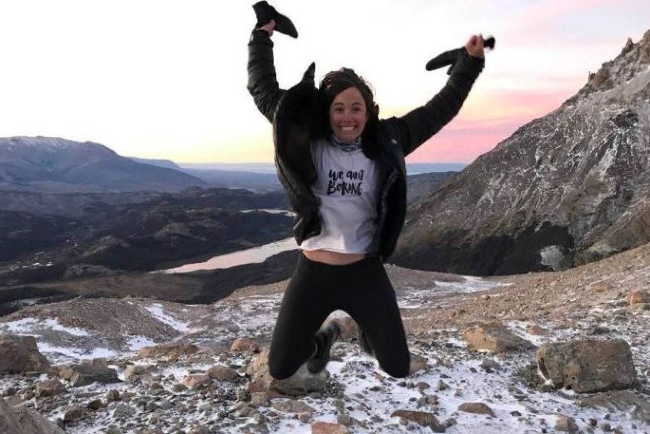 Australian Lucy Barnard jumps for joy after reaching another milestone on her trek from one end of the world to the other.