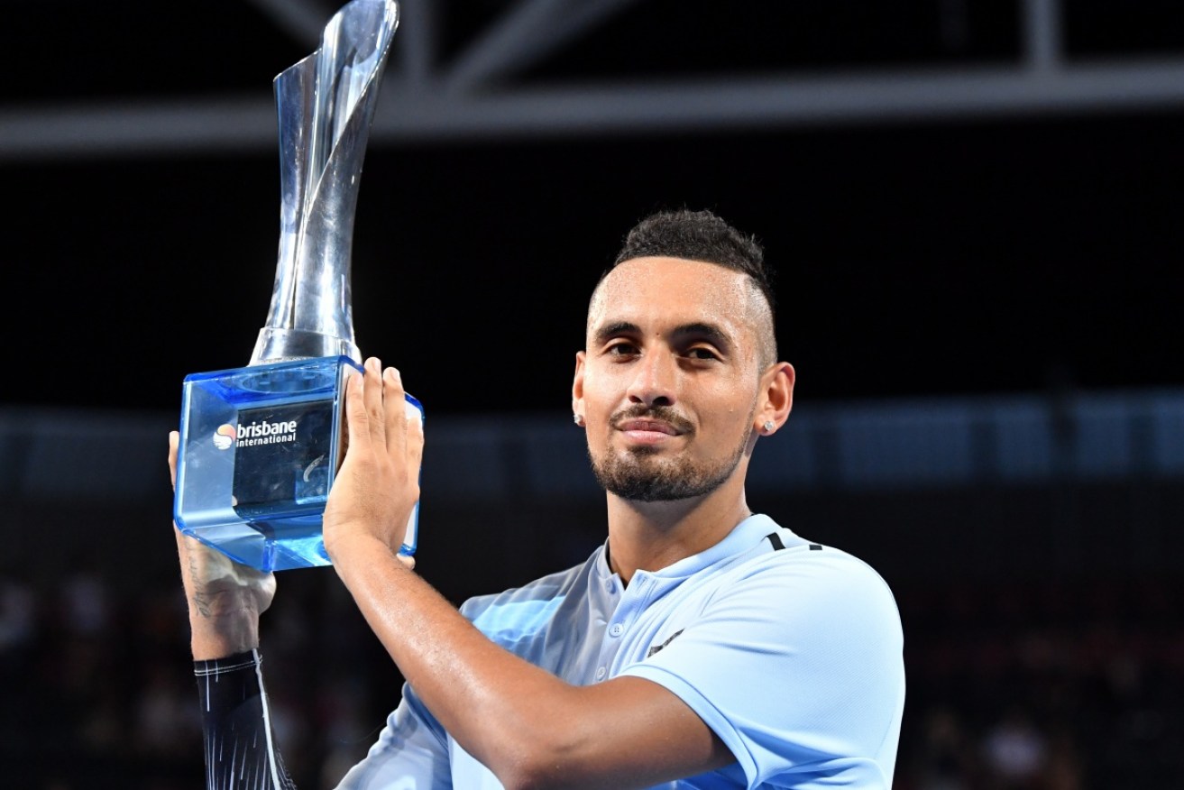 Nick Kyrgios is seen with the trophy after winning the men's Final against Ryan Harrison at the Brisbane International Tennis Tournament.