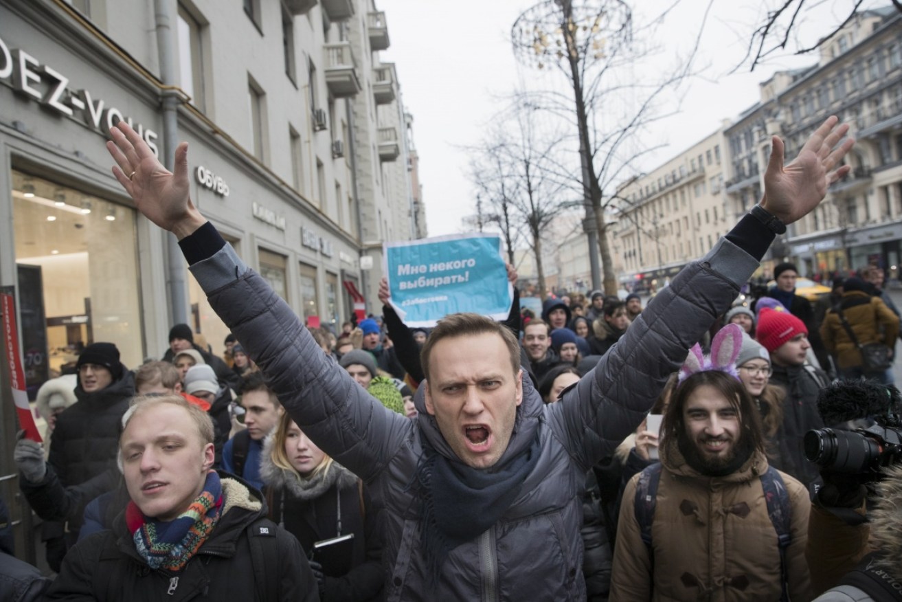 Alexei Navalny was wrestled to the ground  by police and dragged feet first into a patrol wagon.