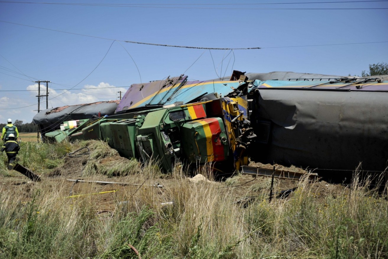 The truck, towing two trailers, was halfway across the tracks when it was hit. 