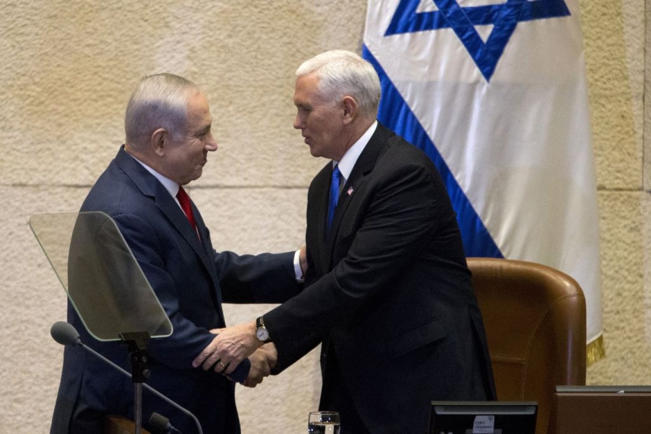 US Vice-President Mike Pence (R) shakes hands with Israeli Prime Minister Benjamin Netanyahu at the parliament in Jerusalem on Monday.