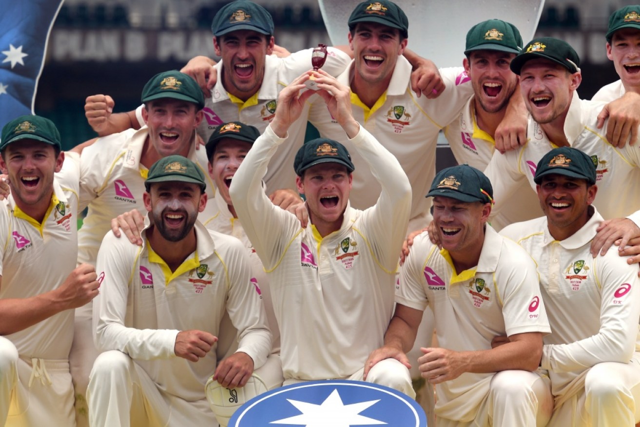 Australia celebrates after retaining the Ashes trophy, defeating England 4-0.