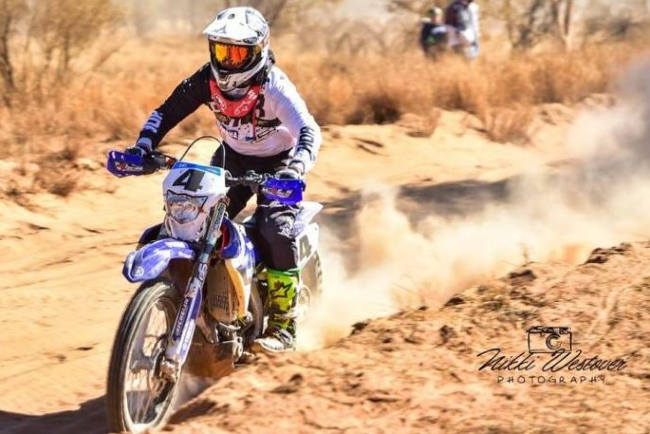 Nursing a shattered hand, Daymon Stokie powers through the dust on his way to victory in 2017's Finke Desert Race.