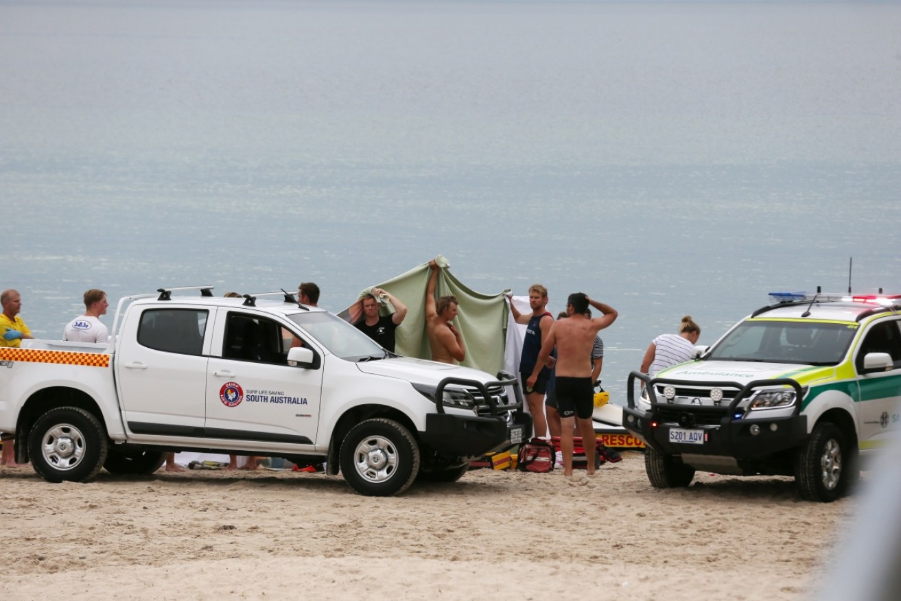 Police, ambulance and surf life savers attend a drowning in Adelaide on December 18.