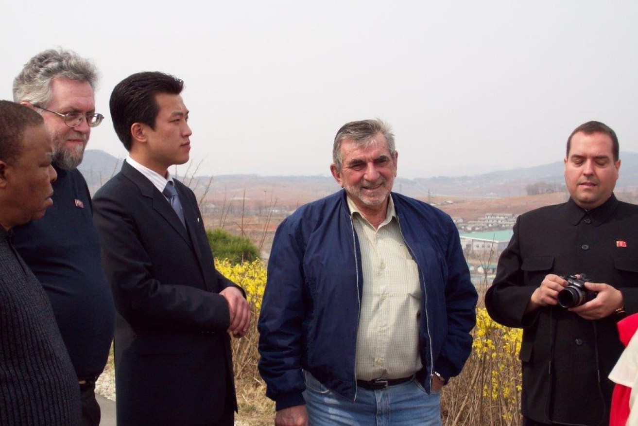 Australian man Raymond Ferguson, centre, at a state-run fruit farm in North Korea with other foreign delegates.