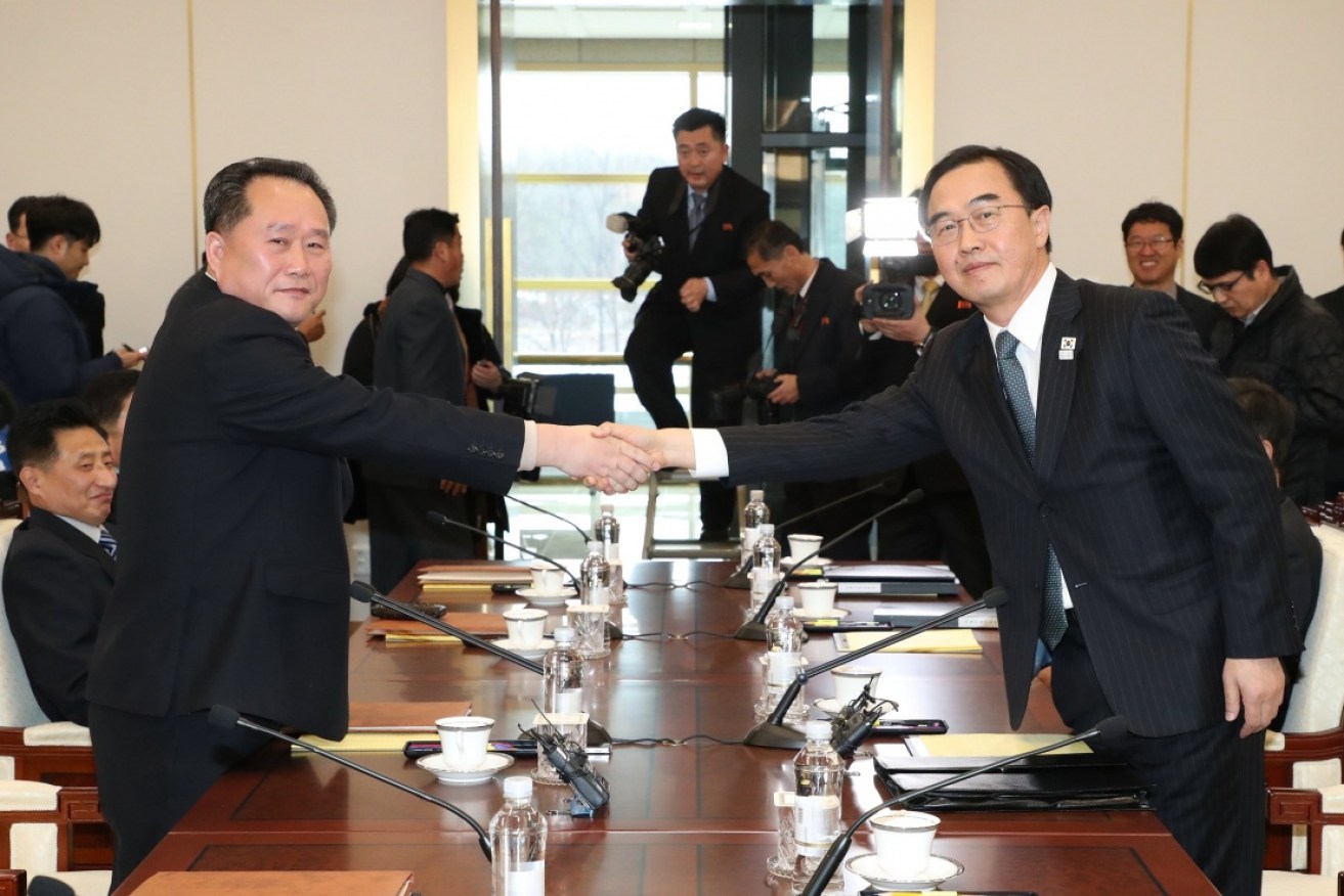 South Korean Unification Minister and chief delegate Cho Myoung-gyon (R) shakes hands with his North Korean counterpart, Ri Son-gwon.
