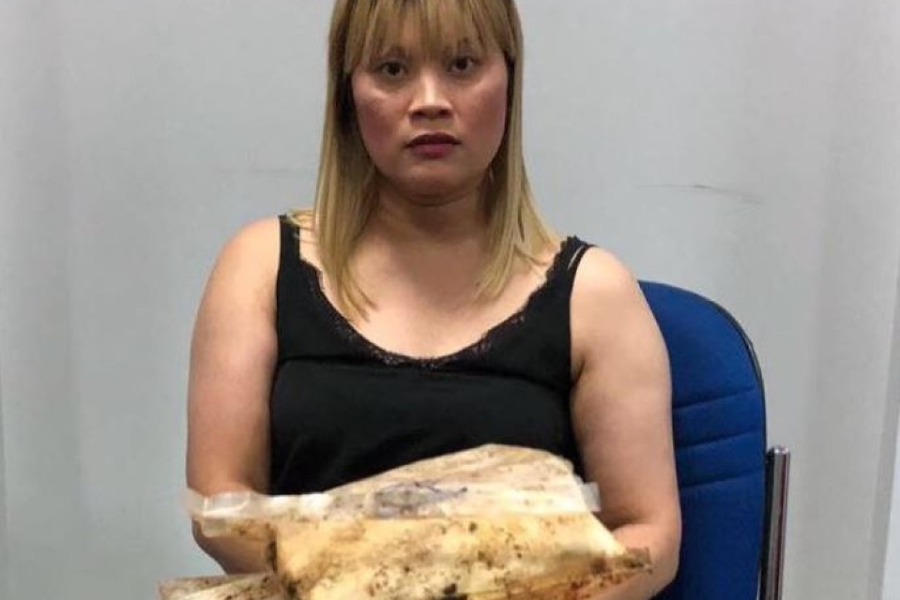Australian woman Ve Thi Tran in custody with the heroin allegedly found in her luggage.