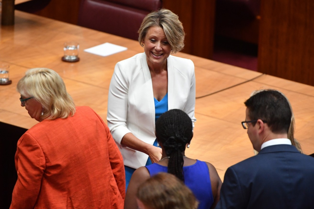 Kristina Keneally is congratulated by fellow senators after being sworn in. 