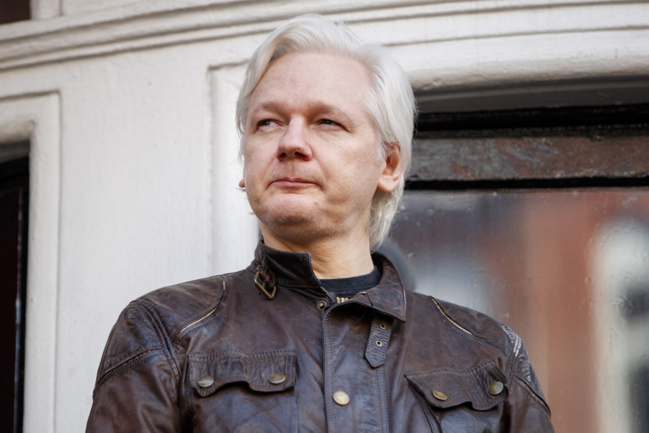 A UK minister has said it is "about time" Julian Assange turned himself over to authorities.