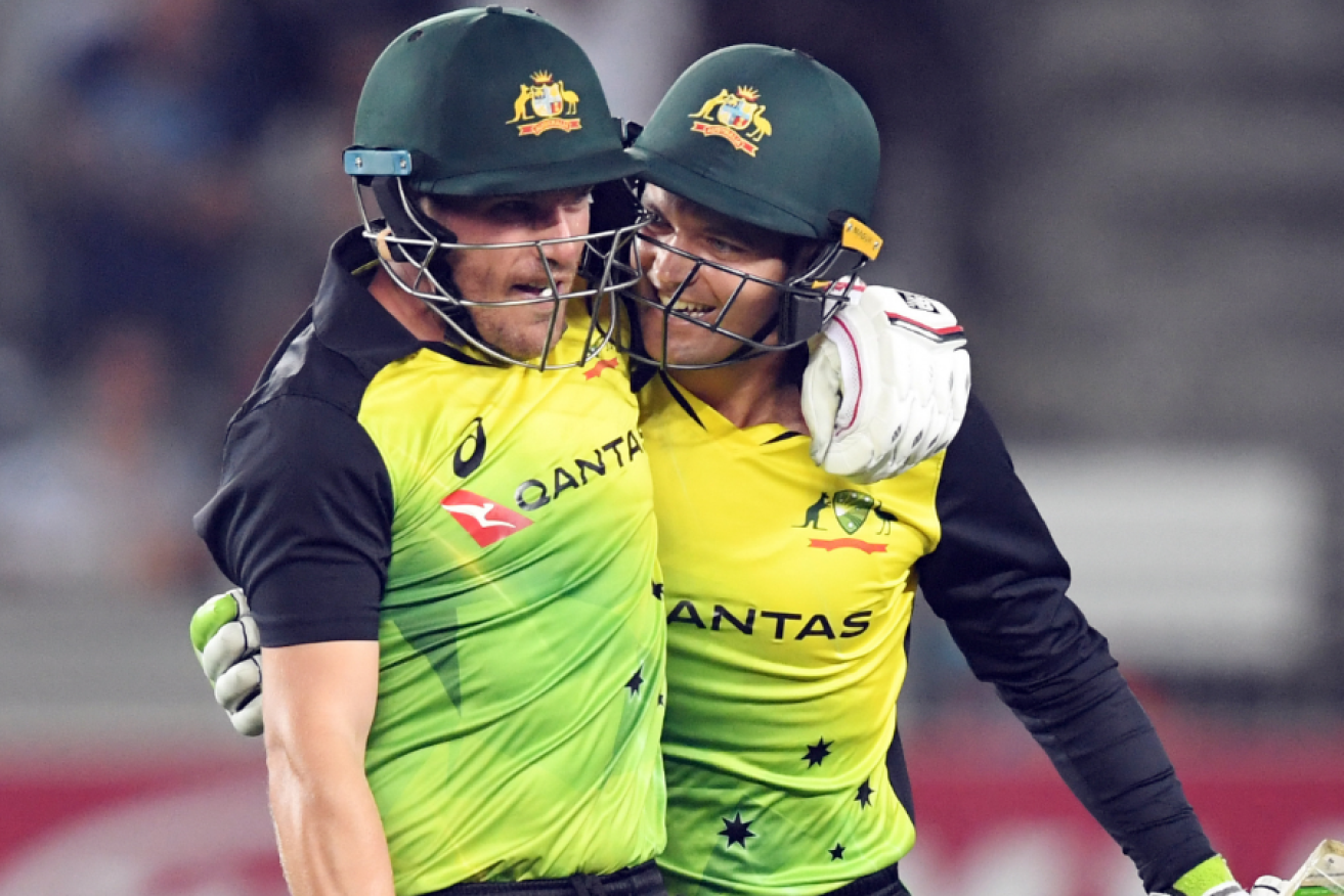 The look on the faces of Aaron Finch (left) left and Alex Carey says it all - a win and a world record.