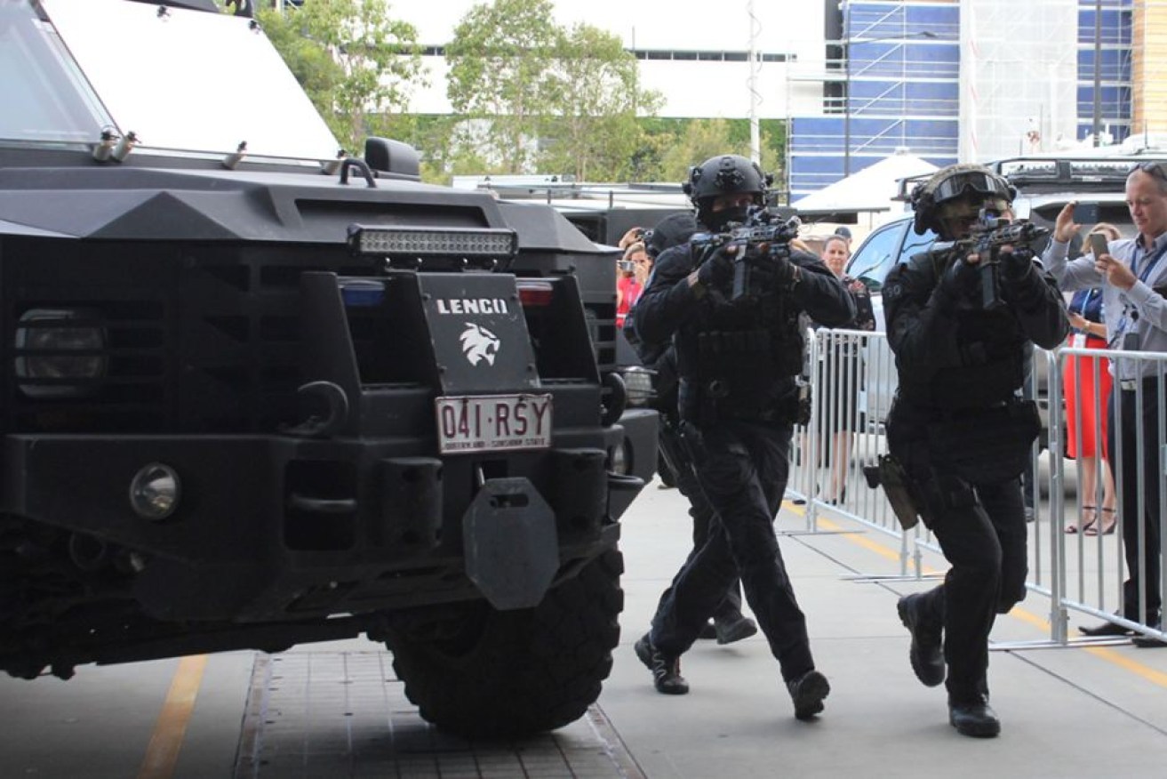 Tactical police at a media event on the Gold Coast take part in a training drill for the Commonwealth Games.