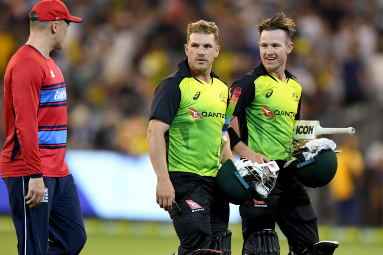 Aaron Finch (centre) and D'Arcy Short  share a parting word with their vanquished foe after blazing Australia to victory in the third Twenty20 clash with England.