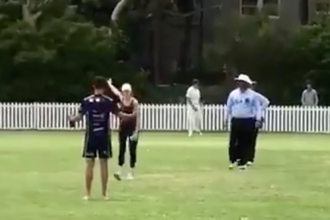 The woman was furious as confused umpires, players and spectators looked on.