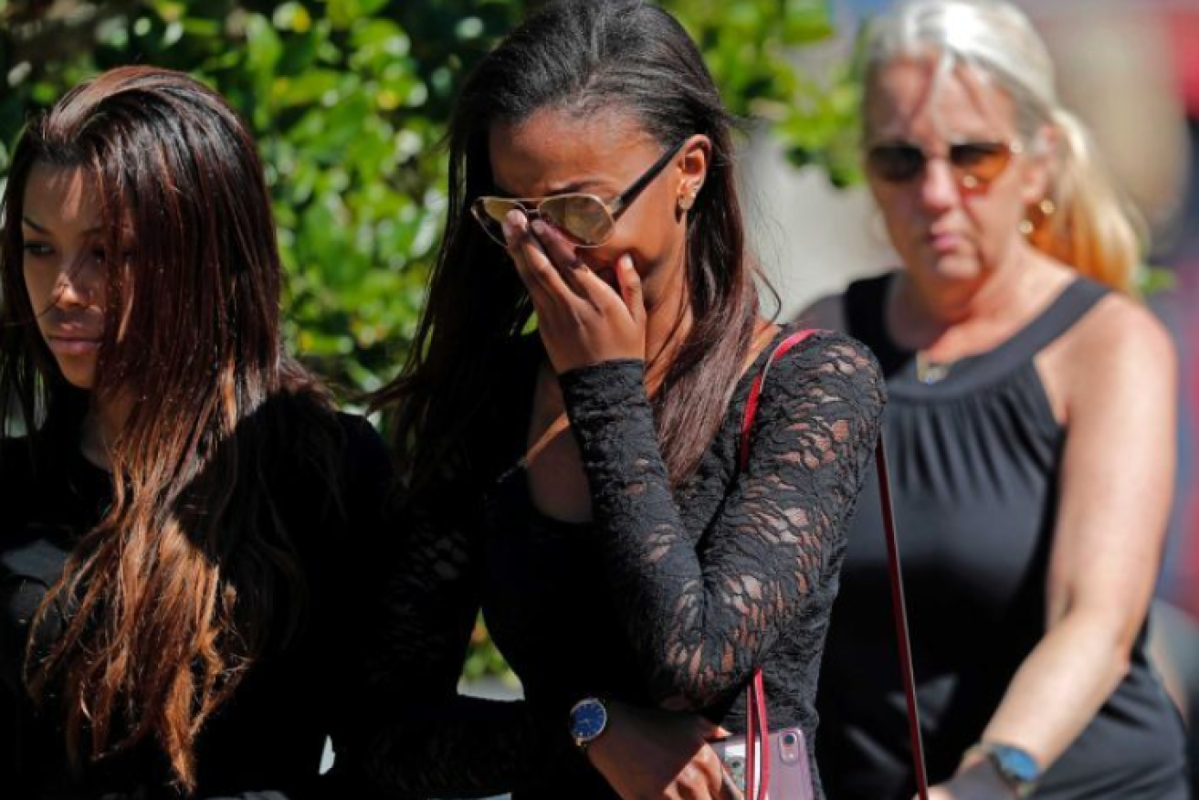 Grief-stricken friends and fellow students leave the funeral of 18-year-old classmate Meadow Pollack.