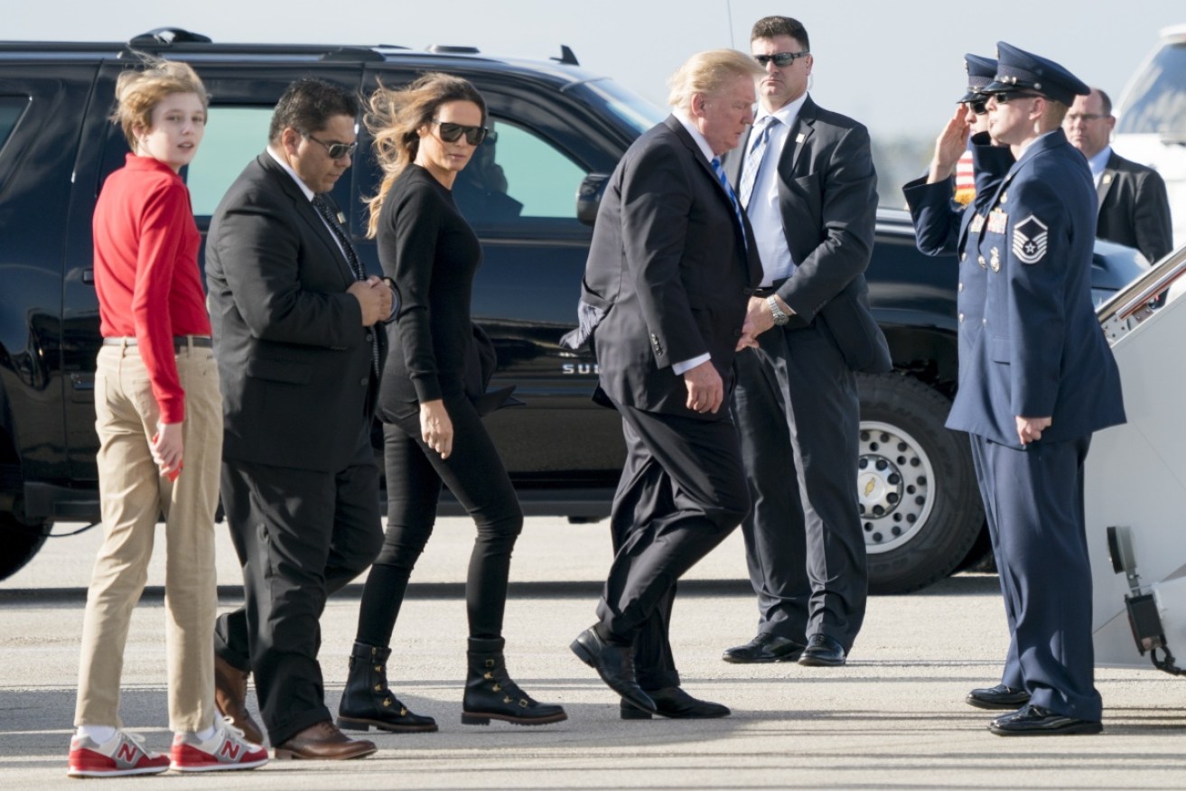 These boots are made for walking? Melania Trump, with husband Donald and son Barron, boards Air Force One on February 19.