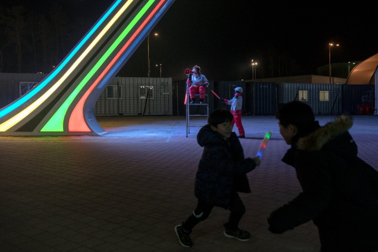 Children play in front of a neon sculpture at Gangneung Olympic Park. Bright colours abound at these Games.