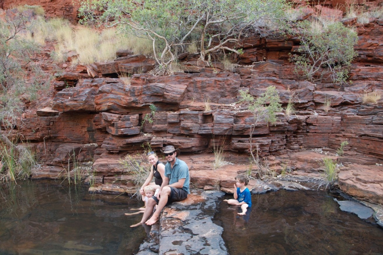 Julia Egerton and Jarrod Hancock withsons Jake, 2, and Henry, 4, at an outback waterhole.