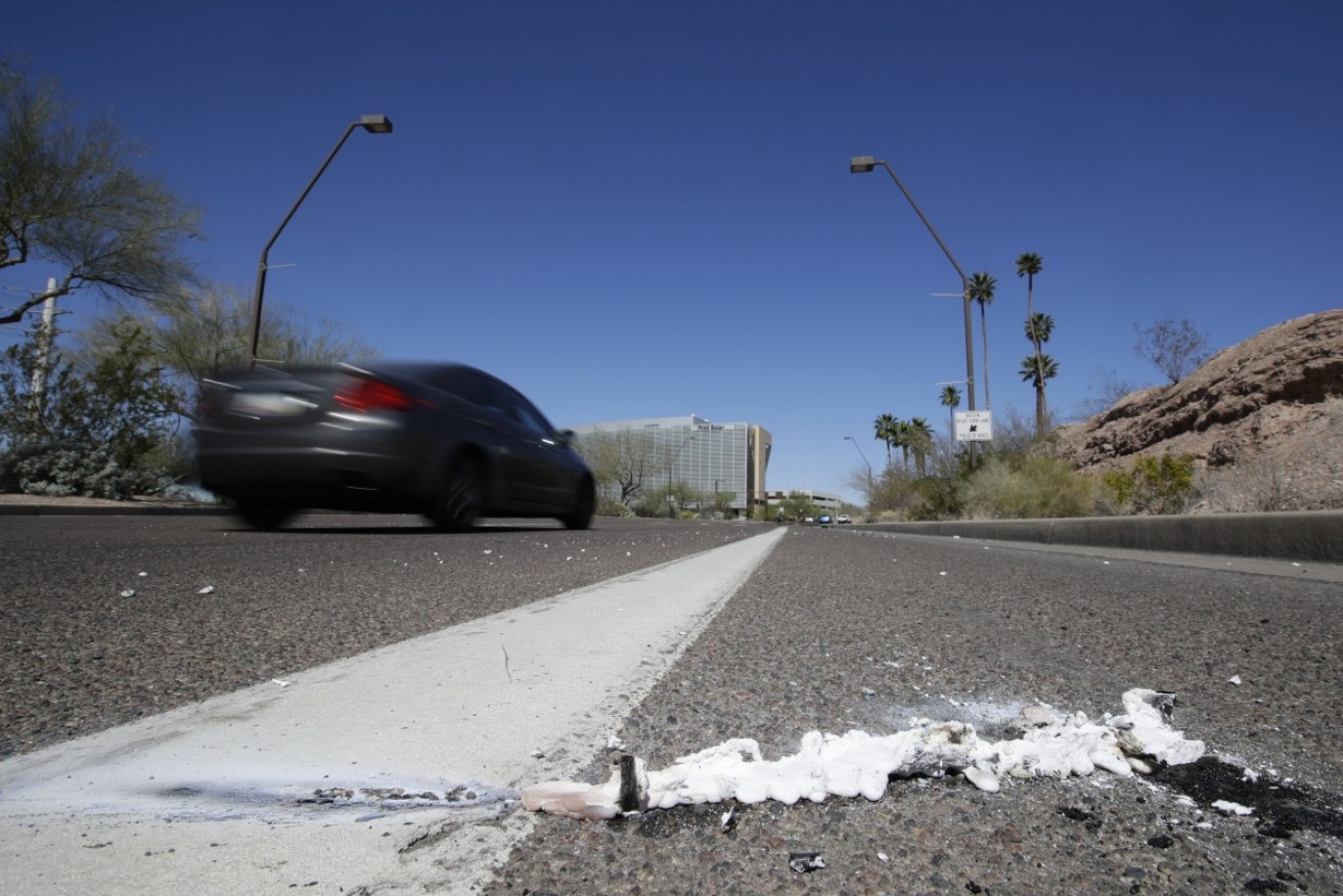 A vehicle goes by the scene of the Uber fatality in Arizona.   