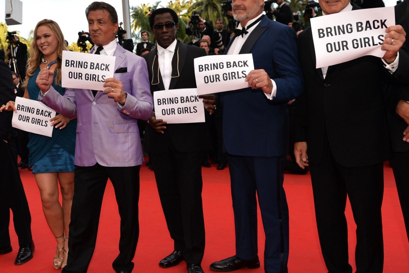 Hollywood stars hold up #Bringbackoutgirls signs on the red carpet.  