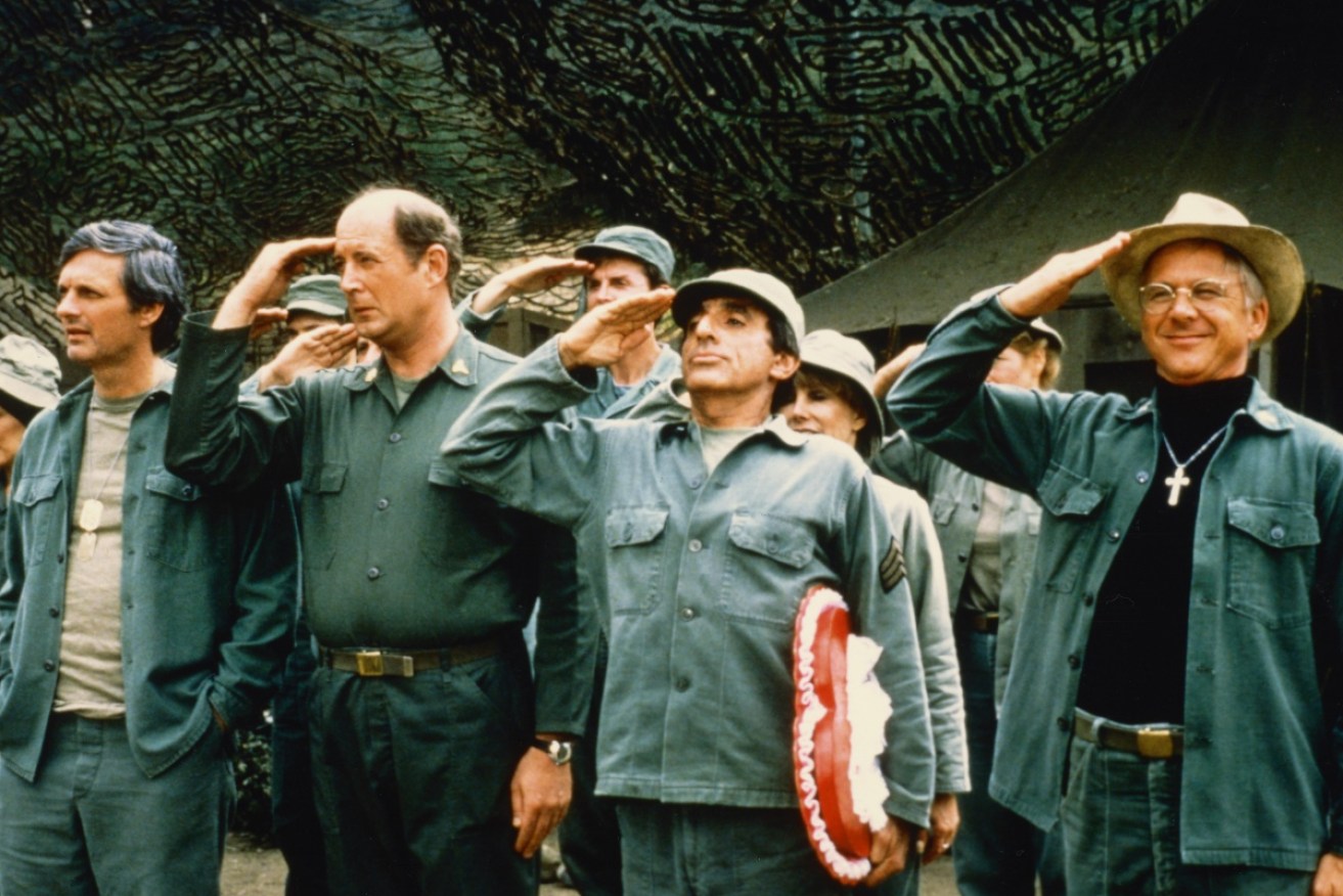 David Ogden Stiers (2L), with M*A*S*H co-stars Alan Alda, Jamie Farr and US actor, and William Christopher.
