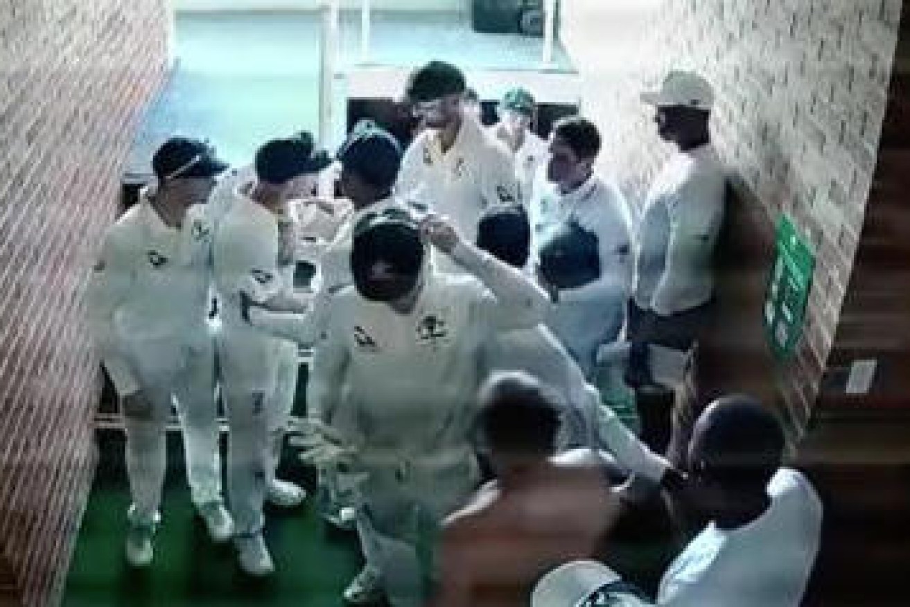 David Warner is restrained by teammates in a stairwell during the First Test in Durban on March 4.