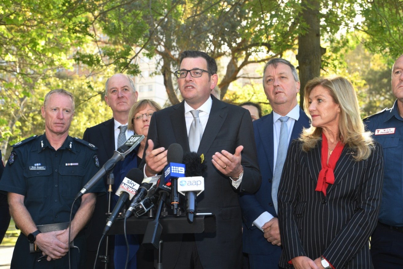 Victoria's Police Minister Lisa Neville (third left) and Health Minister Martin Foley (third right) will join Planning Minister Richard Wynne (second left) in quitting politics at the November election.