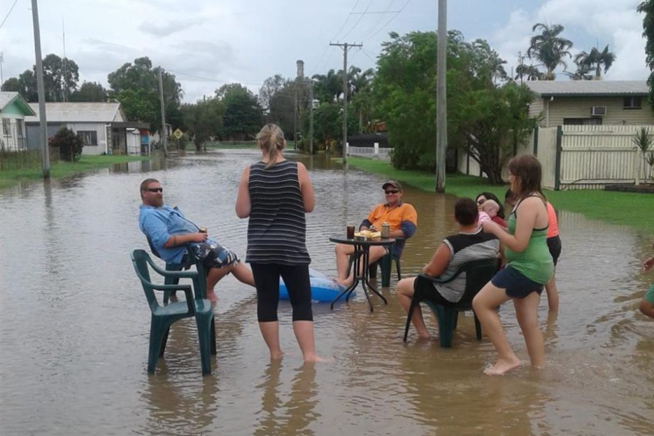 Residents hold a 'flood party' in floodwaters at Giru.