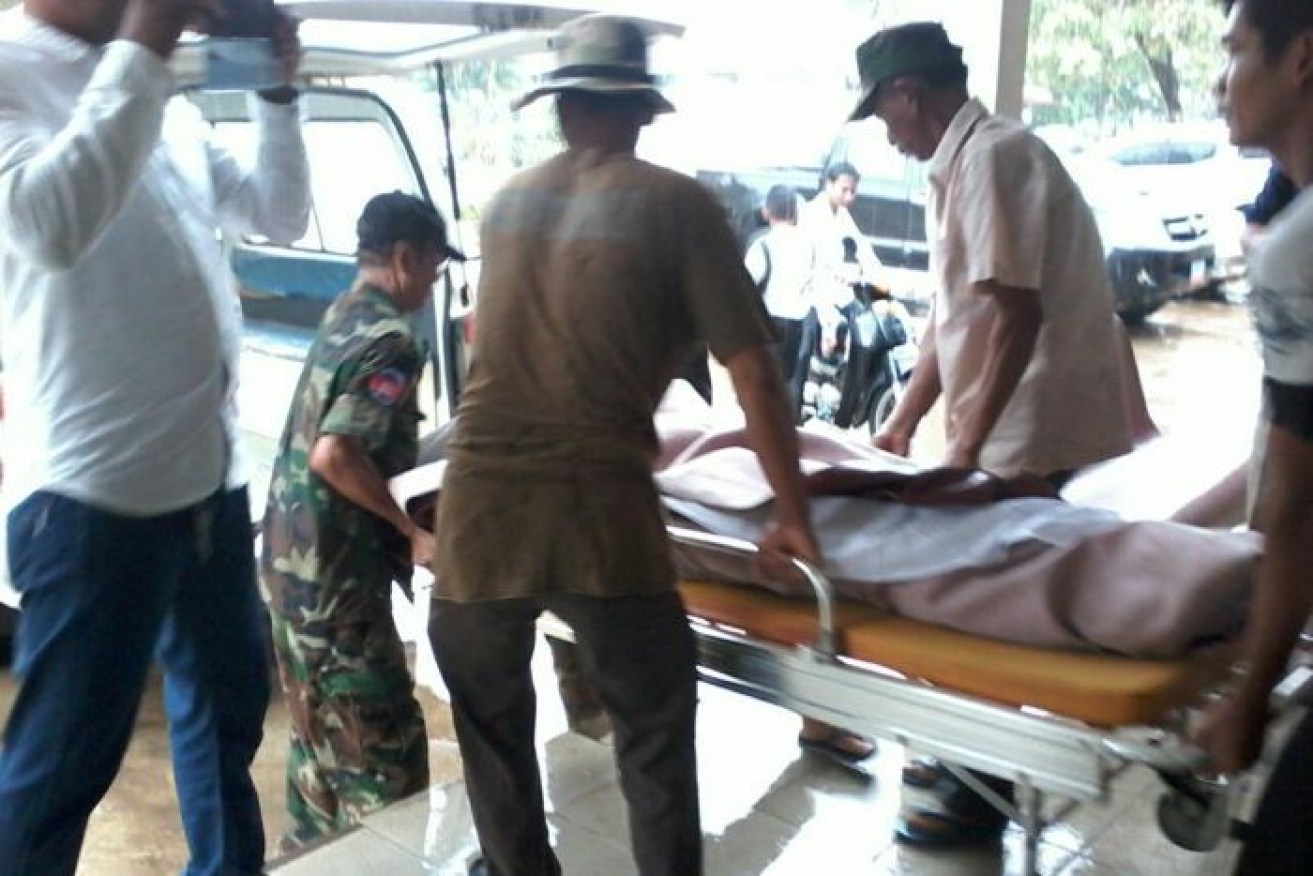 Men carry a stretcher after an explosion at a shooting range in Cambodia that killed two people.