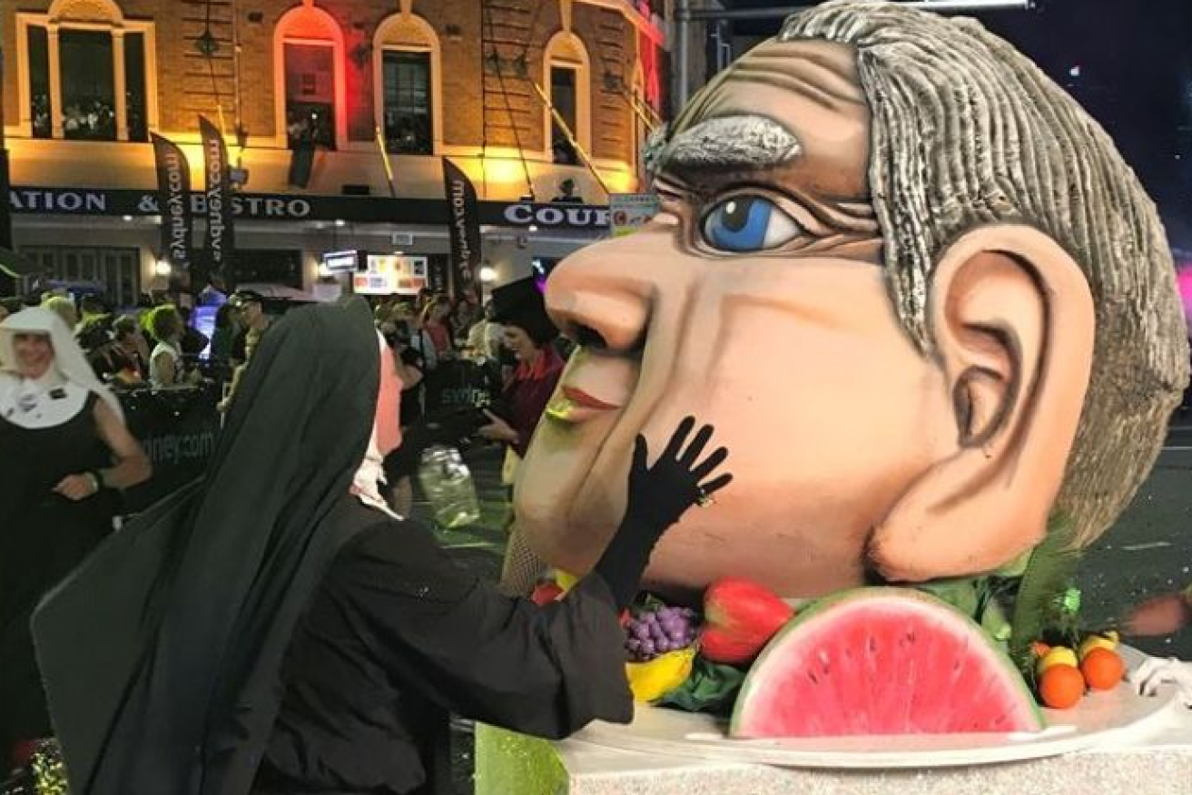 Sister act: a Mardi Gras reveller lays a mocking hand on an effigy of gay-rights opponent Fred Nile.