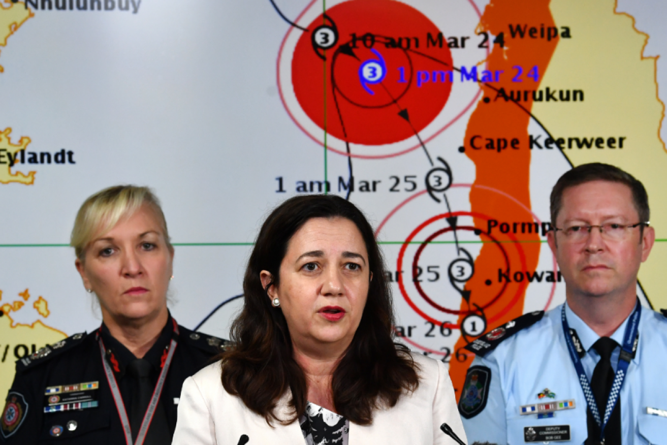 Flanked by Emergency Services chief Katarina Carroll  and Police Deputy Commissioner Bob Gee, Premier Annastacia Palaszczuk  details preparations for Nora's big blow. 