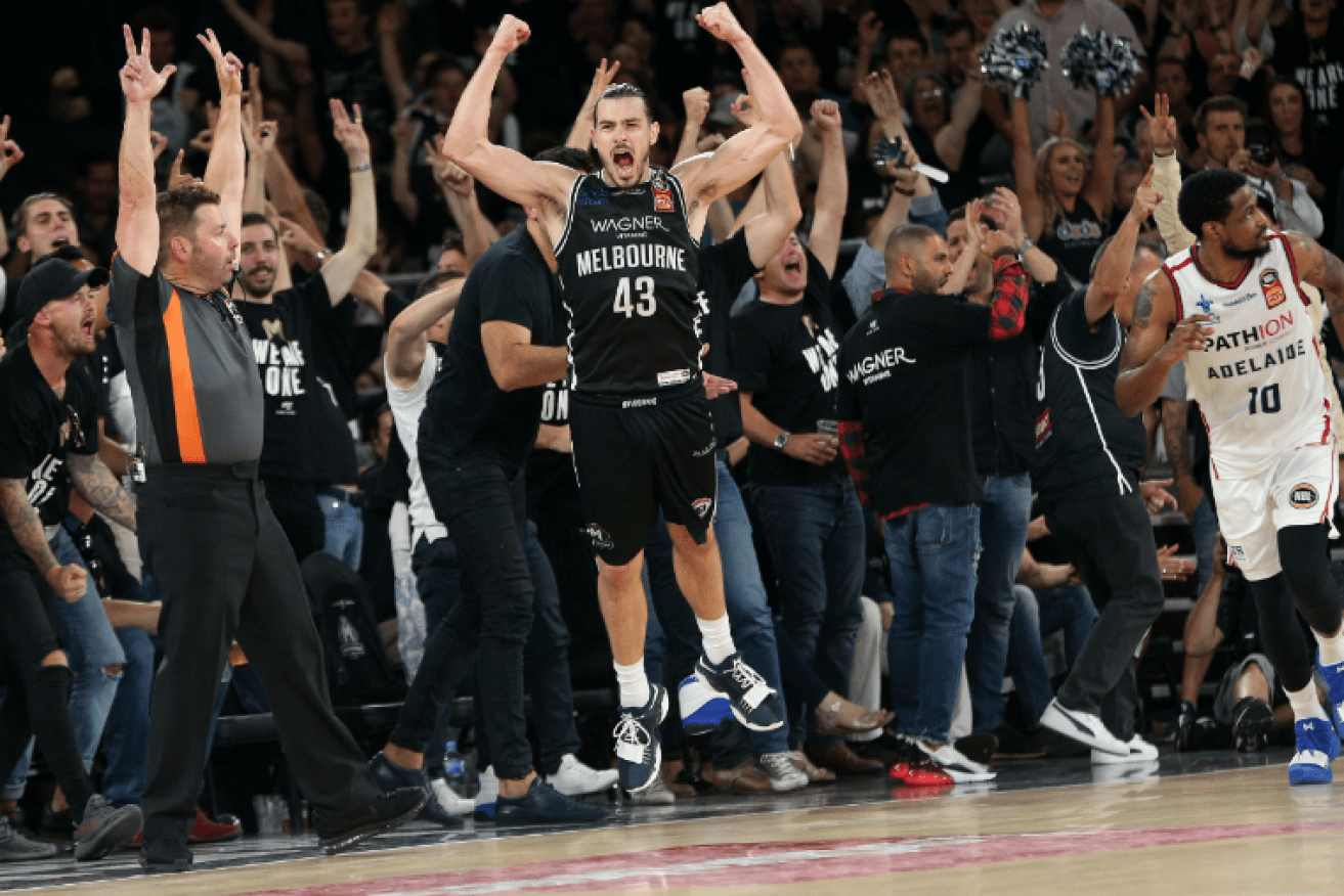 Players leap to their feet as Melbourne United cements its championship-winning lead with just seconds to go. 