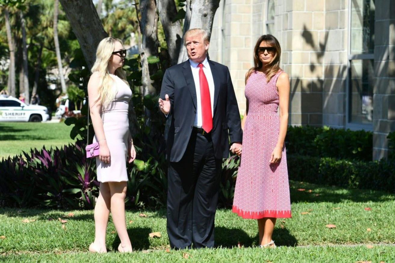 Donald Trump (C) with First Lady Melania Trump (R) and daughter Tiffany Trump (L) arrives at an Easter service in Palm Beach, Florida.